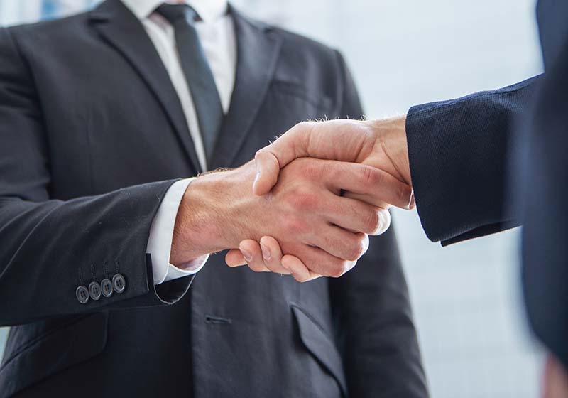 Worthington shaking hands with client